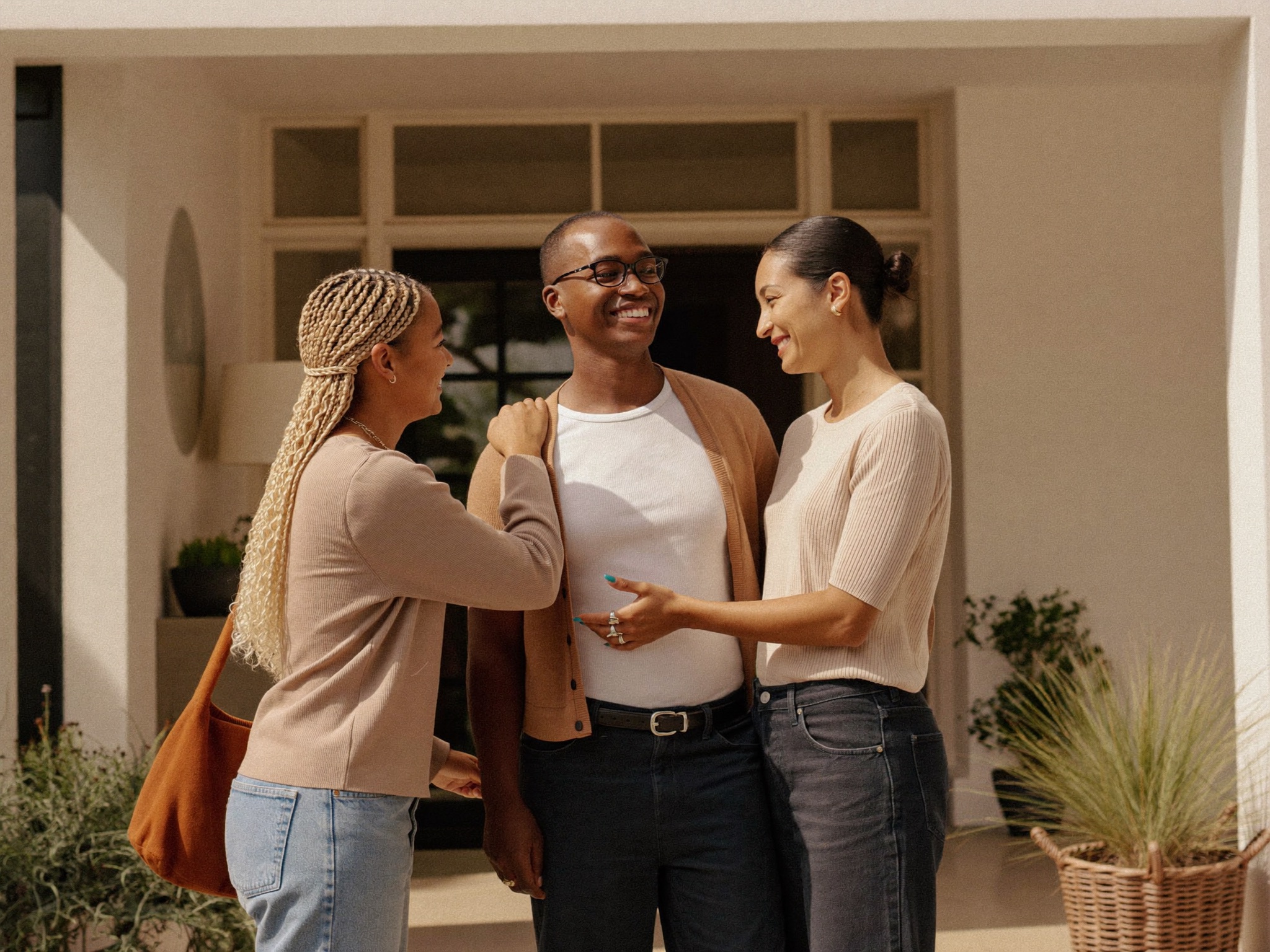 A host welcoming a new housemate at the front door